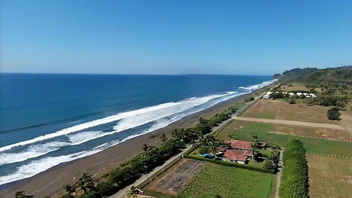 Aerial view of property and beach